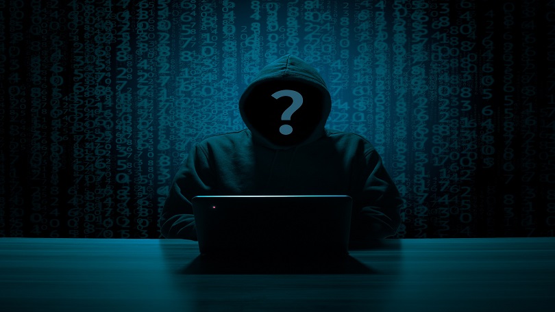 An image of the gloomy and dark man in front of the laptop, with a question mark on his invisible face, in the article discussing protecting children from online predators