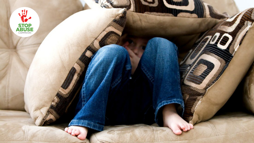 A photo of a lonely child hidden behind pillows, like it's just furniture, indicating an article on childhood emotional neglect.